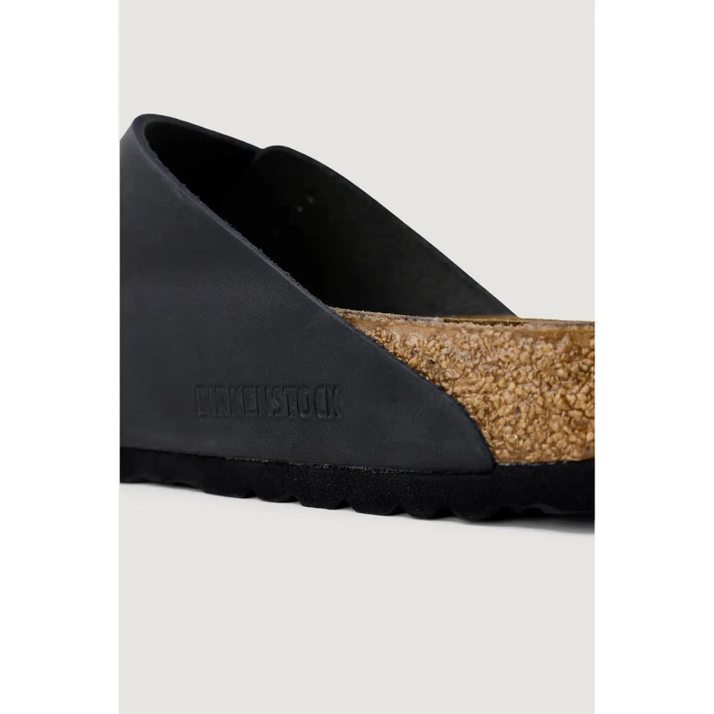 Birkenstock women black leather slippers size 3 with textured cork footbed and rubber sole visible from the back side
