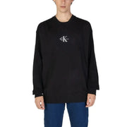 Black Calvin Klein sweater featuring a small CK logo on the chest for men’s fashion
