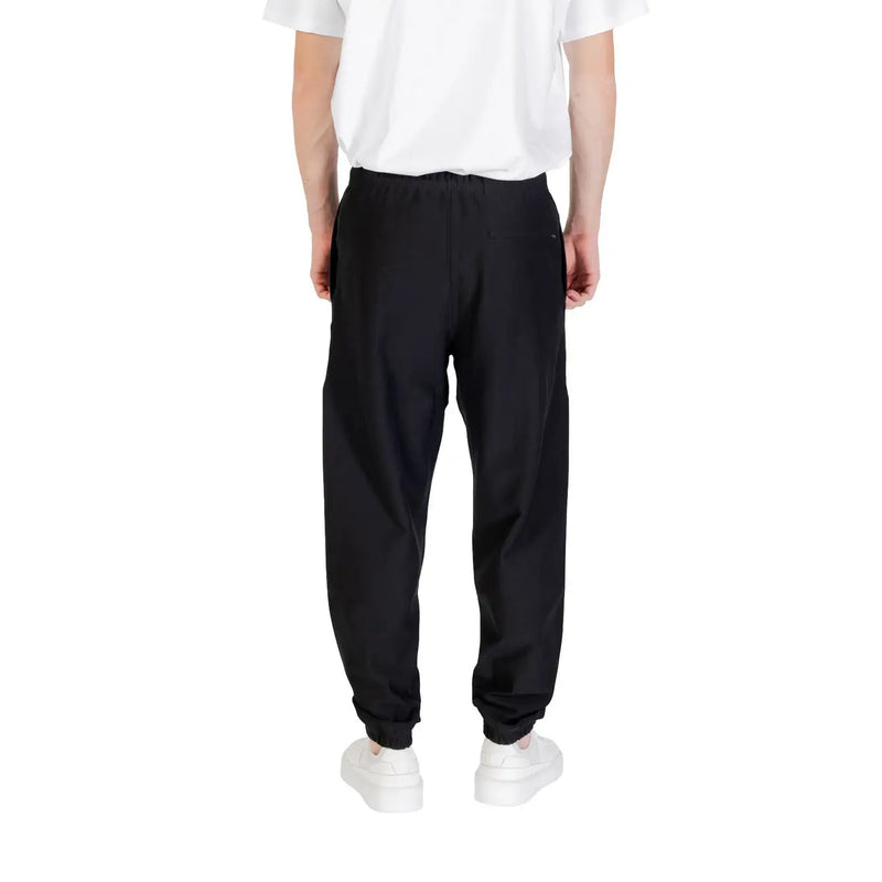 Black calvin klein sweatpants slim fit with elastic waistband drawstring and elastic cuffs in black fabric
