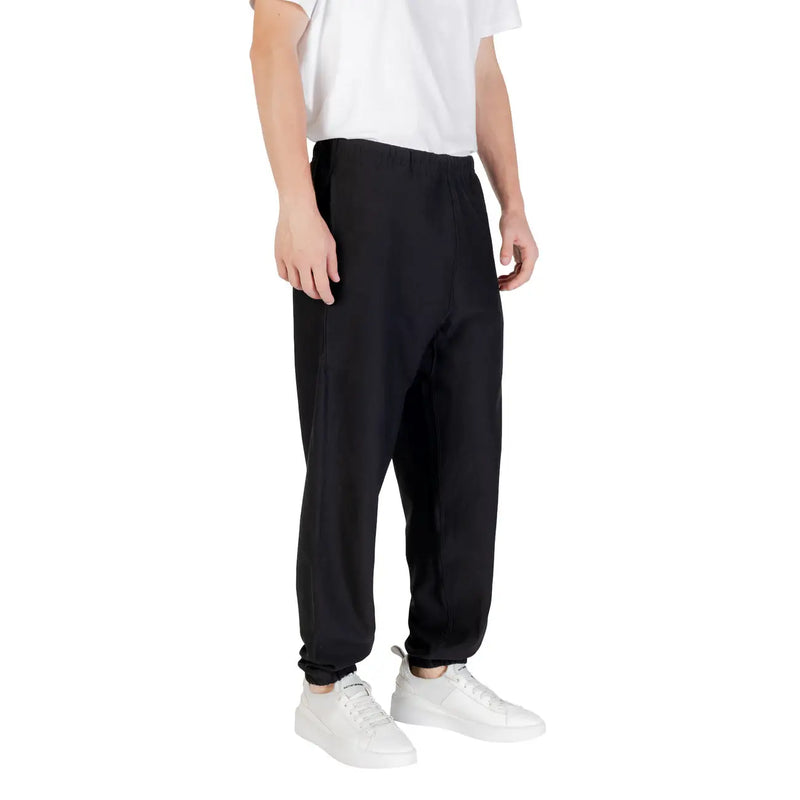 Black Calvin Klein sweatpants in tapered black fabric with elastic cuffs and a relaxed fit