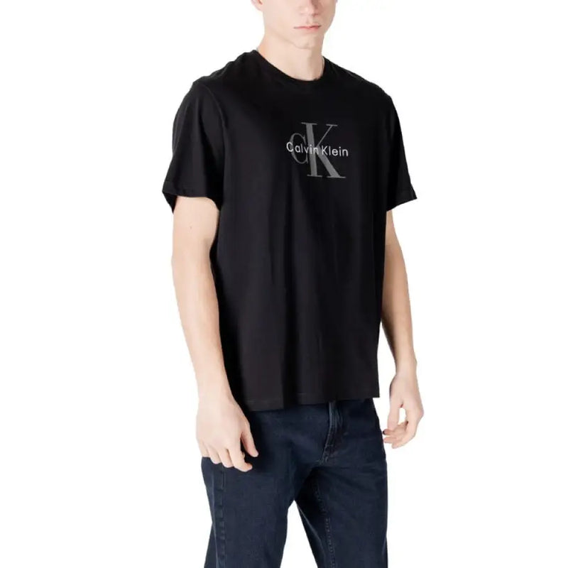 Black Calvin Klein T shirt displayed with dark blue jeans in a fashion product image