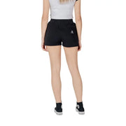 Women’s black Converse shorts paired with matching sneakers on a stylish display