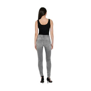 Black cotton blend sleeveless tank top for women paired with high-waisted slim-fit gray denim jeans back view