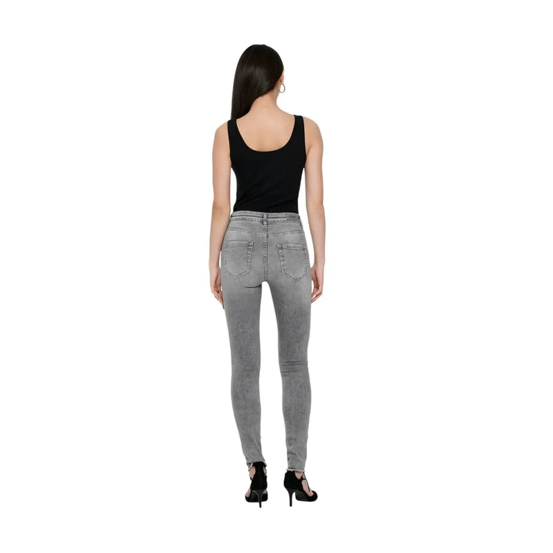 Black cotton blend sleeveless tank top for women paired with high-waisted slim-fit gray denim jeans back view