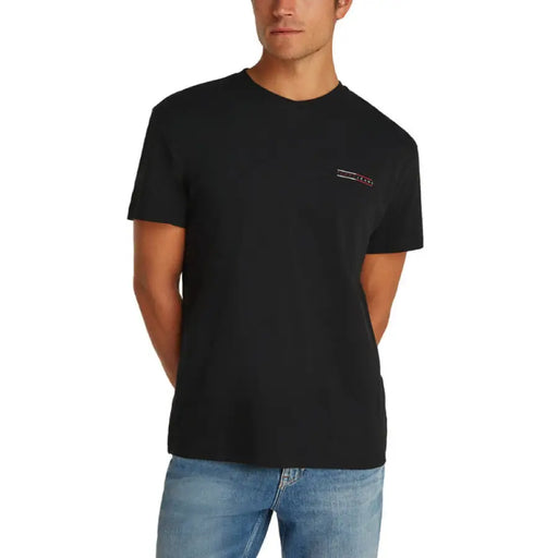 Black crewneck T-shirt displayed with denim shorts in a men’s fashion product image