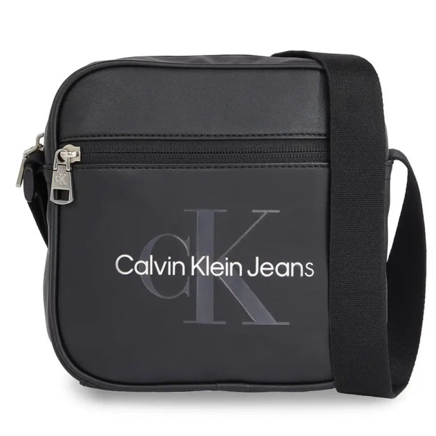 Calvin Klein black cross body bag for urban style clothing on city background