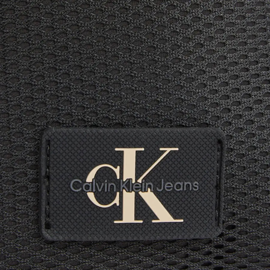 
                      
                        Calvin Klein logo on men’s bag, showcasing urban city fashion
                      
                    