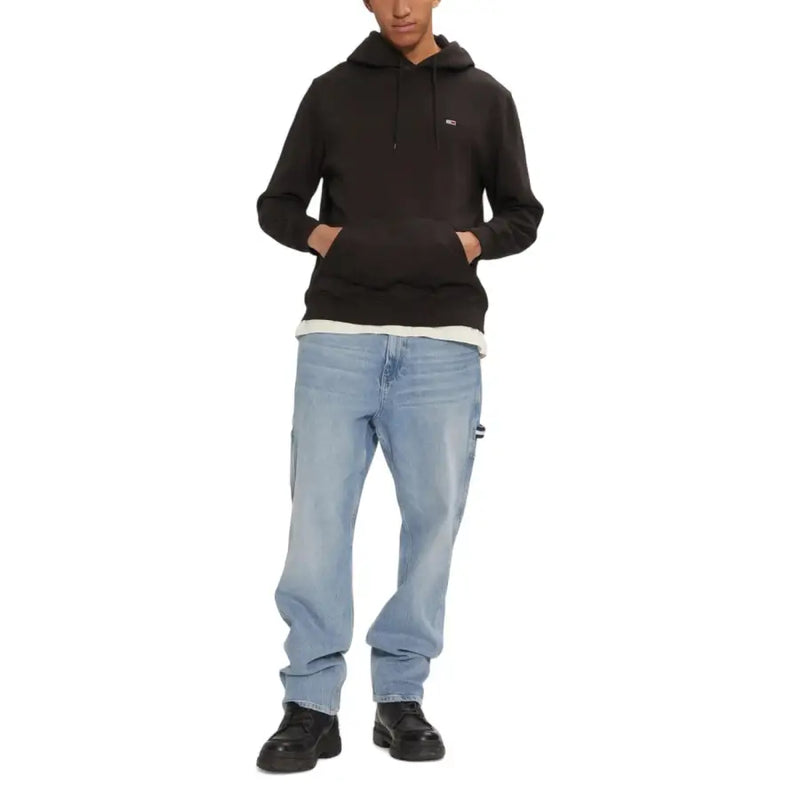 Dark brown hoodie with light wash blue jeans and black shoes for men’s fall winter fashion