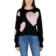 Black long sleeve round neck viscose knit top for women with pink heart patches on a black sweater