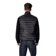Black quilted vest with knit sleeves featuring a high collar and sleeveless design in a sleek puffer style