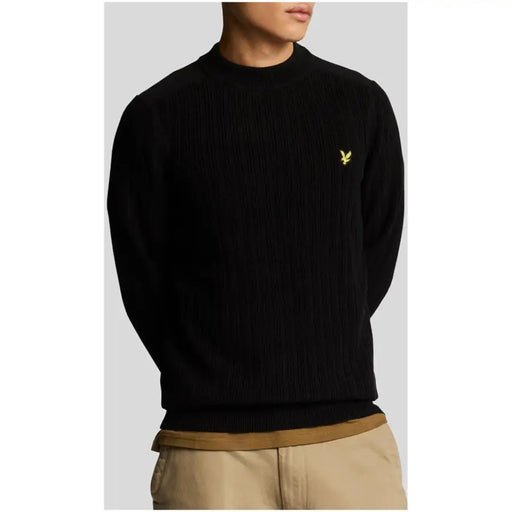 Black ribbed knit sweater displayed on a model in the Navy Blue Ribbed Knit Sweater product image