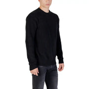 Black ribbed knit sweater displayed on a mannequin, ideal for casual wear