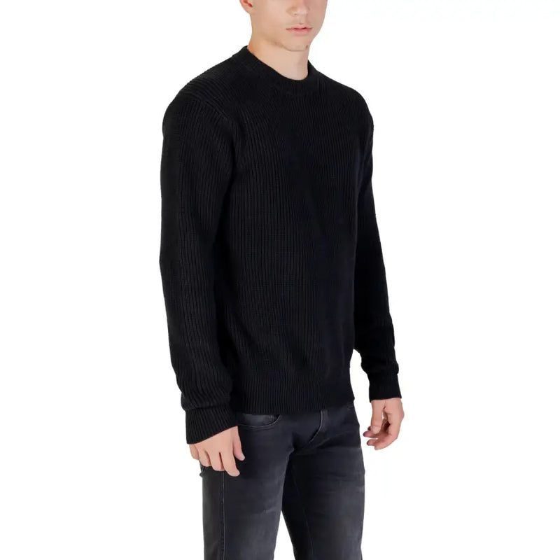 Black ribbed knit sweater displayed on a mannequin, ideal for casual wear