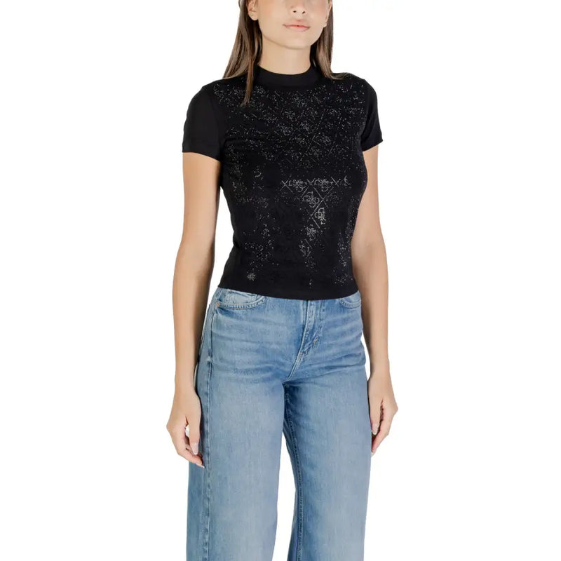 Black short-sleeve mock neck top with subtle geometric pattern paired with light wash wide-leg jeans