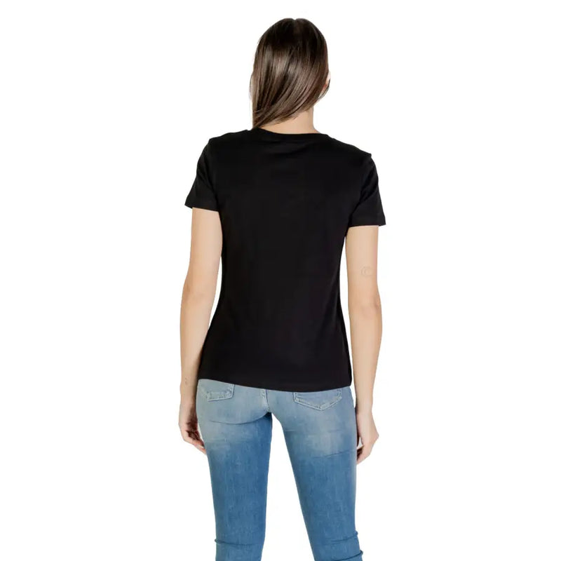 Black short-sleeve Guess Active women T-shirt paired with blue jeans