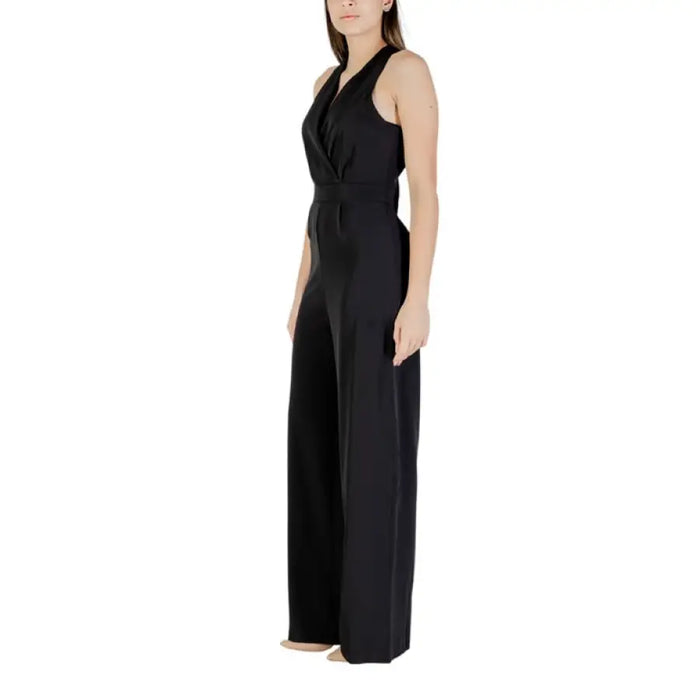 Black sleeveless wide-leg halter jumpsuit displayed in a fashion catalog