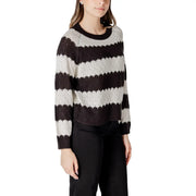 A cozy black and white striped acrylic sweater with ribbed crew neck and cuffs in a long sleeve round neck style