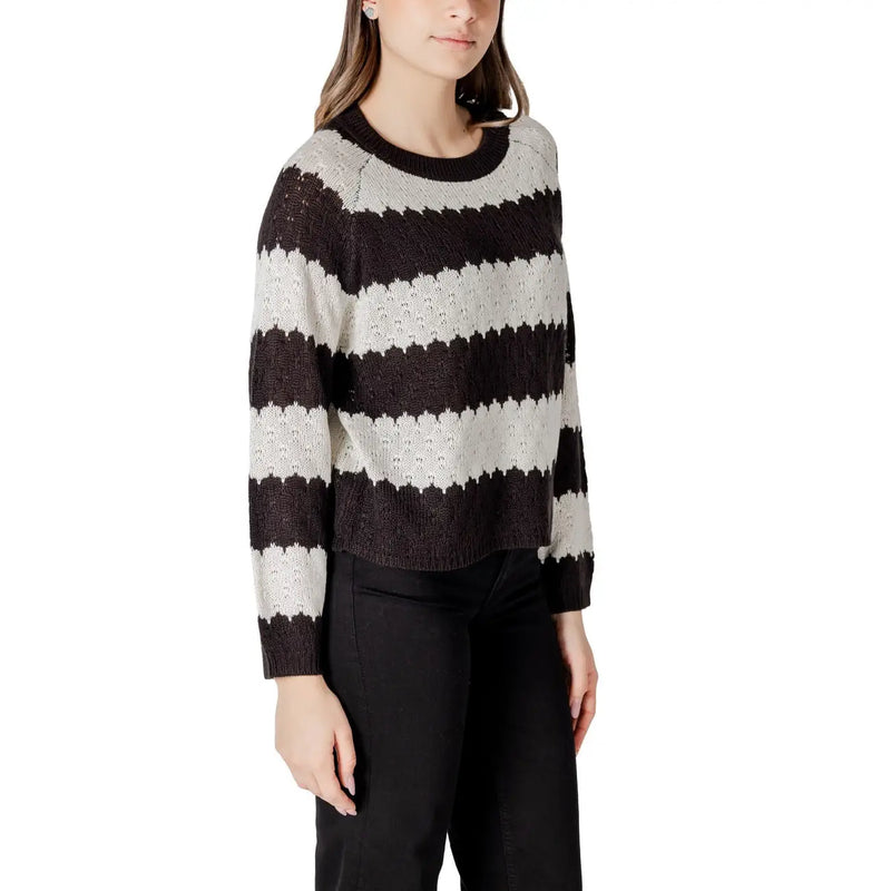 A cozy black and white striped acrylic sweater with ribbed crew neck and cuffs in a long sleeve round neck style