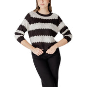 Black and white horizontally striped acrylic knit sweater with round neck and slightly cropped textured silhouette