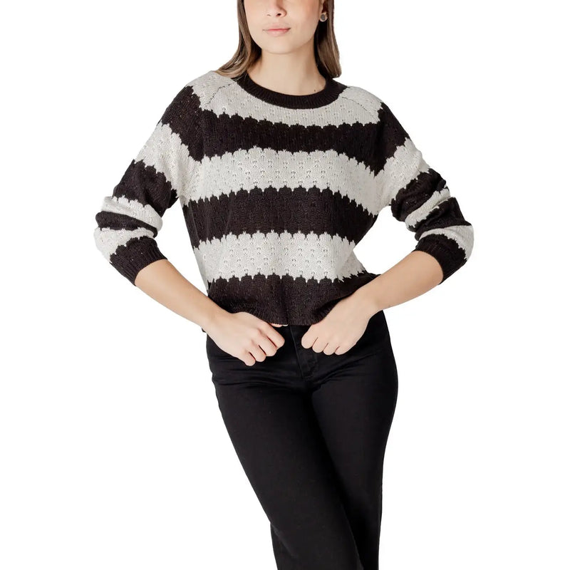 Black and white horizontally striped acrylic knit sweater with round neck and slightly cropped textured silhouette