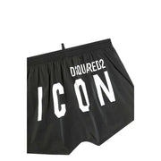 Black dsquared2 swim trunks in black featuring bold white icon lettering and a white drawstring on the front