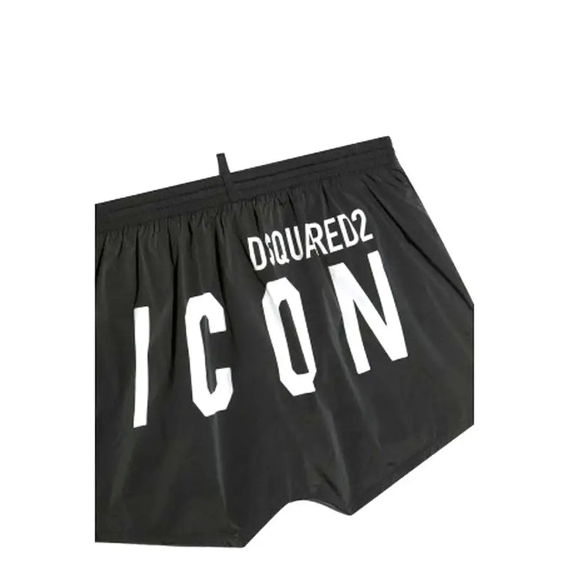 Black dsquared2 swim trunks in black featuring bold white icon lettering and a white drawstring on the front