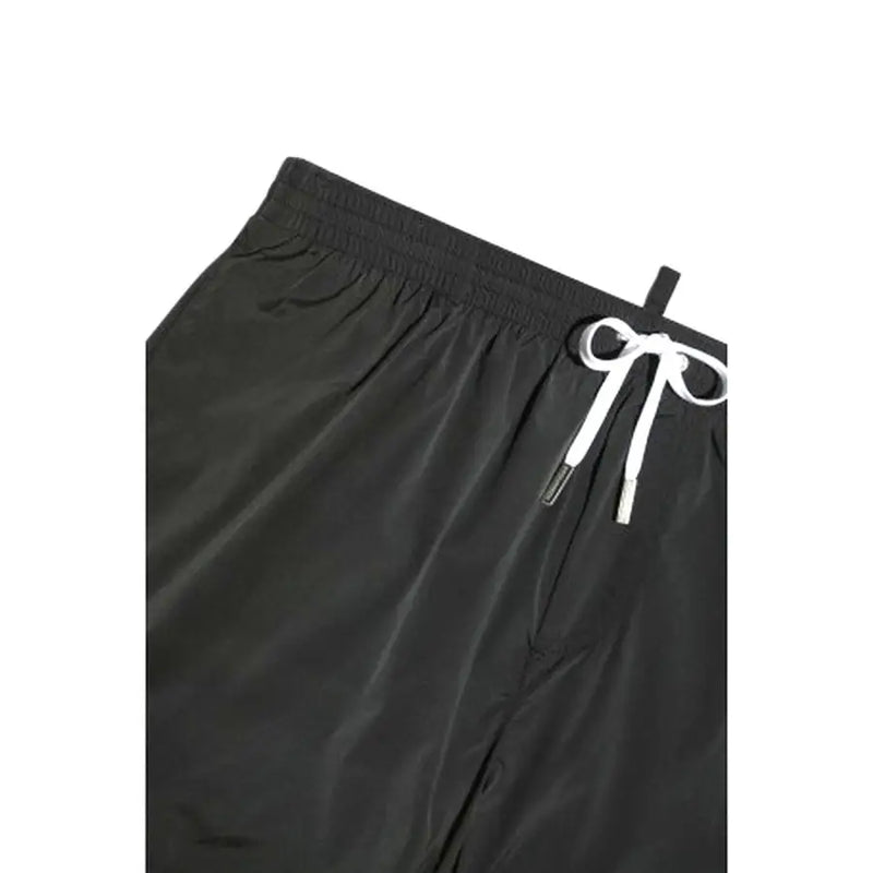 Black swim trunks with a white drawstring featuring metallic aglets and the icon dsquared2 logo on black fabric