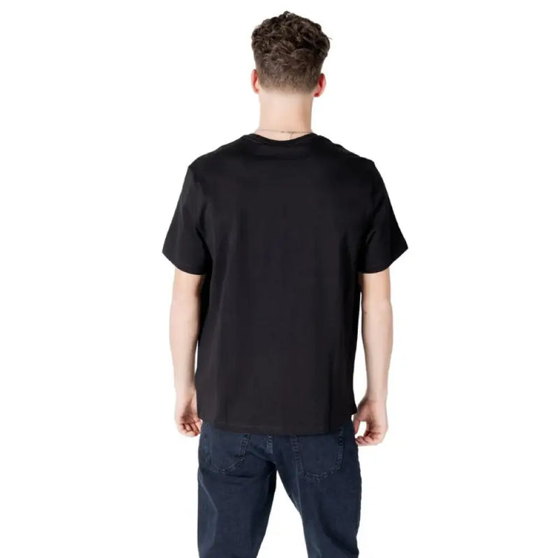 Black Calvin Klein T shirt paired with dark blue jeans for a stylish casual look