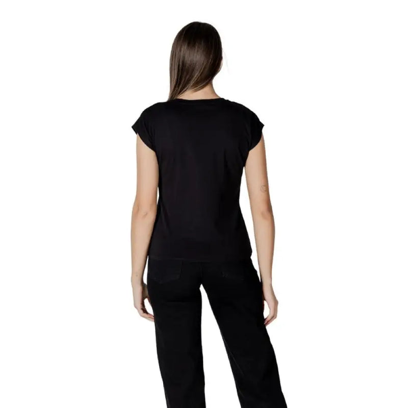 Black studded T shirt paired with matching black pants for a stylish outfit display