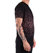 Black T shirt with pink splatter pattern featuring pink speckles on the fabric
