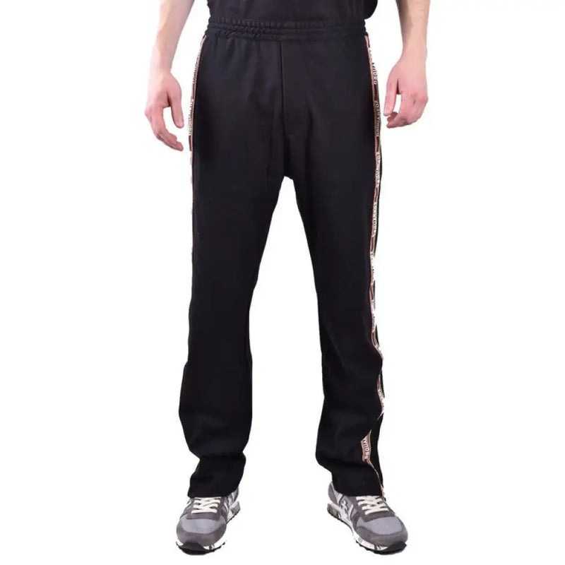 Black track pants with stylish side stripes displayed in the product listing