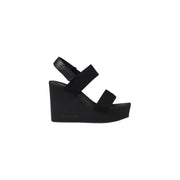 Black wedge sandal displayed in the product image showcasing stylish footwear