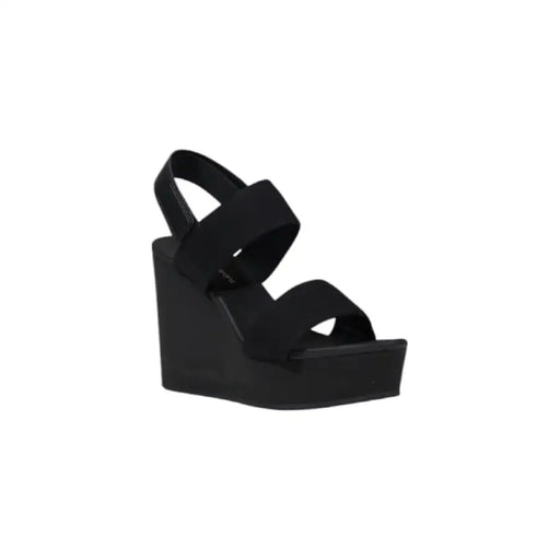 Black wedge sandal showcasing stylish open-toe design and durable heel construction