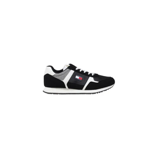 Black and white Tommy Hilfiger sneaker displayed in a product image