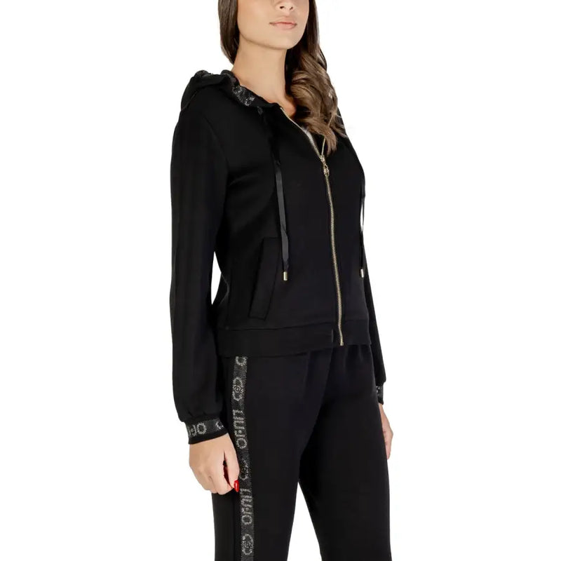 Black women’s tracksuit featuring a zippered hoodie and side-stripe pants for stylish comfort