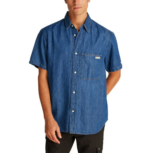 Men’s blue denim short-sleeved shirt displayed with cargo pants in the product image