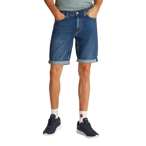 Men’s green T-shirt paired with stylish blue denim shorts for casual wear