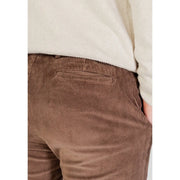 Brown corduroy trousers with subtle ribbed texture and classic back pocket design shown from the back side by Borghese