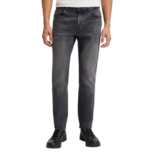 Charcoal gray slim fit jeans with black stitching and pockets, by levi’s 512 model.