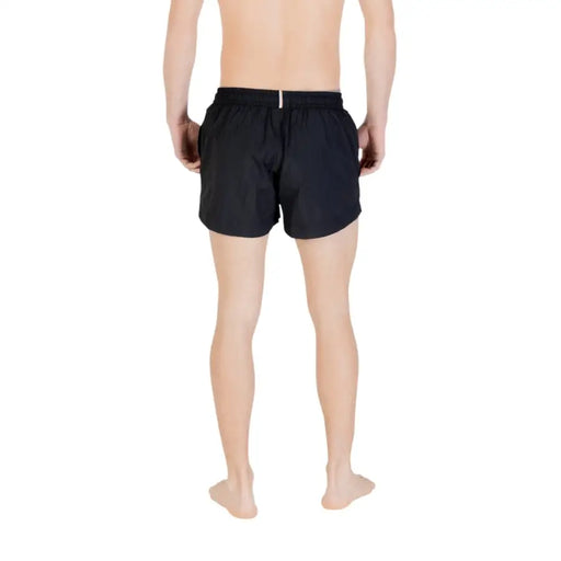 Back view of boss men swimwear black polyamide lace up swim trunks with elastic waistband and white tag