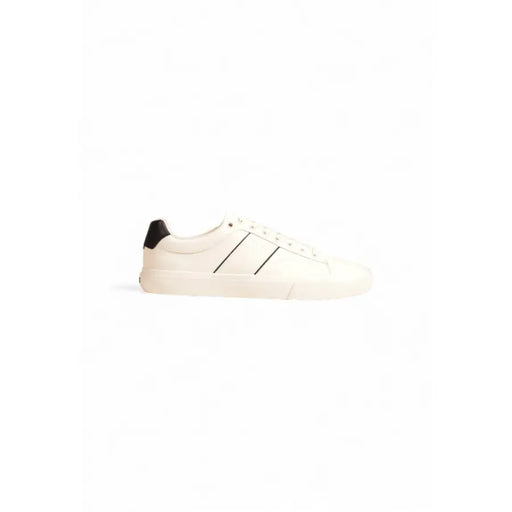 White leather low-top sneaker with black accents and rubber sole.
