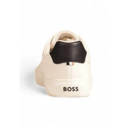 Cream-colored leather boss white sneaker for men with black heel tab and branding on the sole fall winter collection