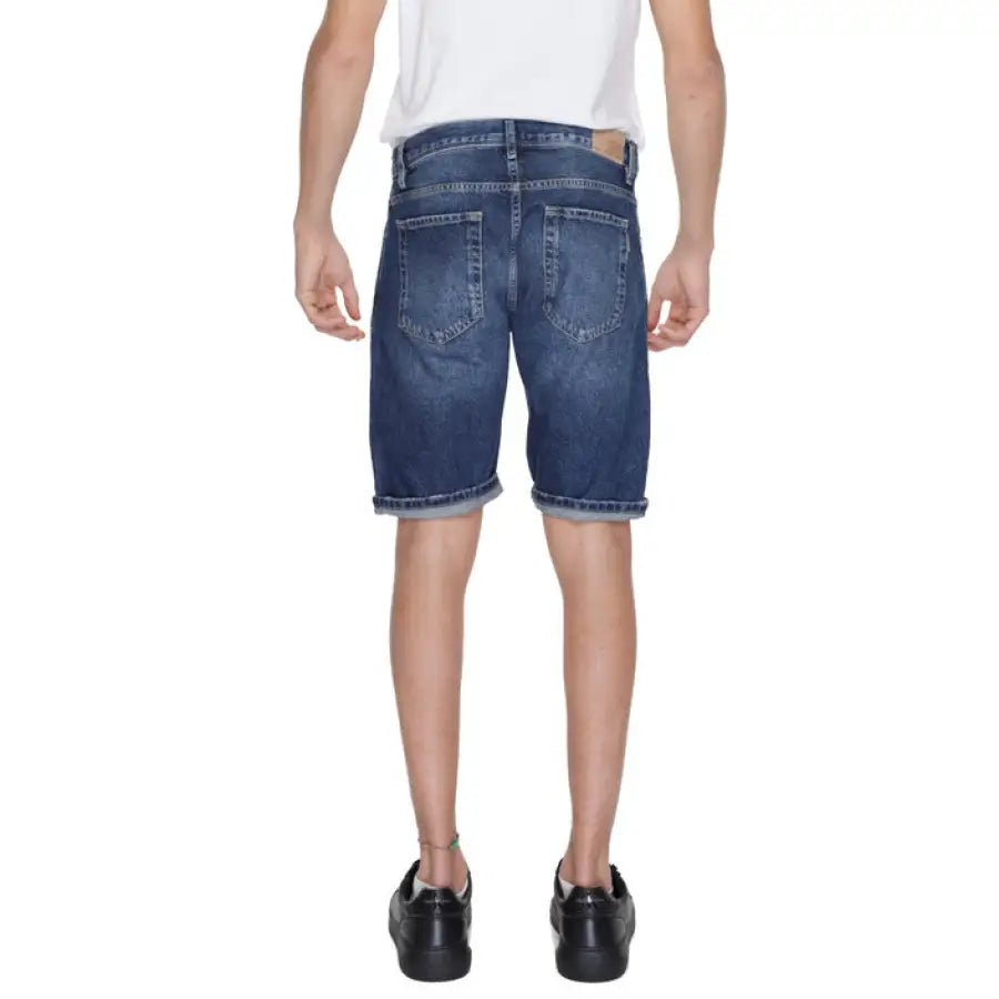 Boy in Antony Morato urban style clothing with white T-shirt and blue shorts