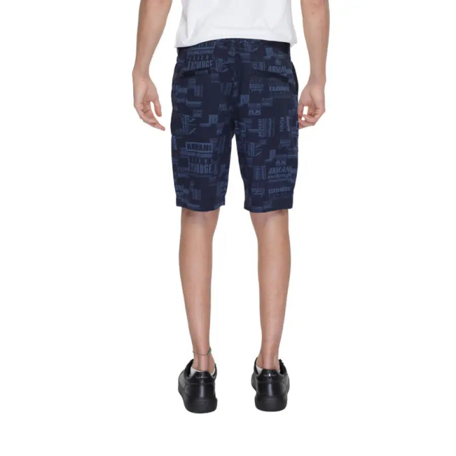 Boy in Armani Exchange outfit showcasing urban style clothing with blue shorts