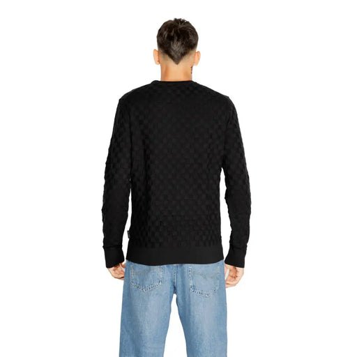 Black cable-knit sweater with a textured pattern and ribbed cuffs, collar, and hem.