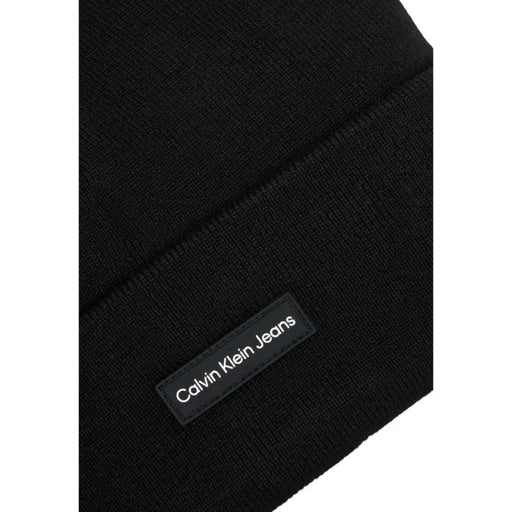 Black calvin klein jeans beanie with logo label.