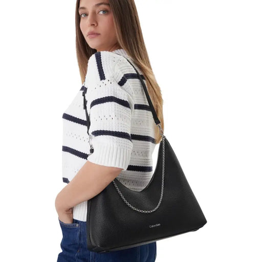 Calvin klein black textured leather hobo bag with silver chain strap and zip pocket in polyurethane material