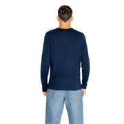 Navy blue crew neck sweater with ribbed cuffs and hem, likely made of cotton or a similar soft material.