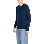 Navy blue crew neck sweater with long sleeves and a relaxed fit.