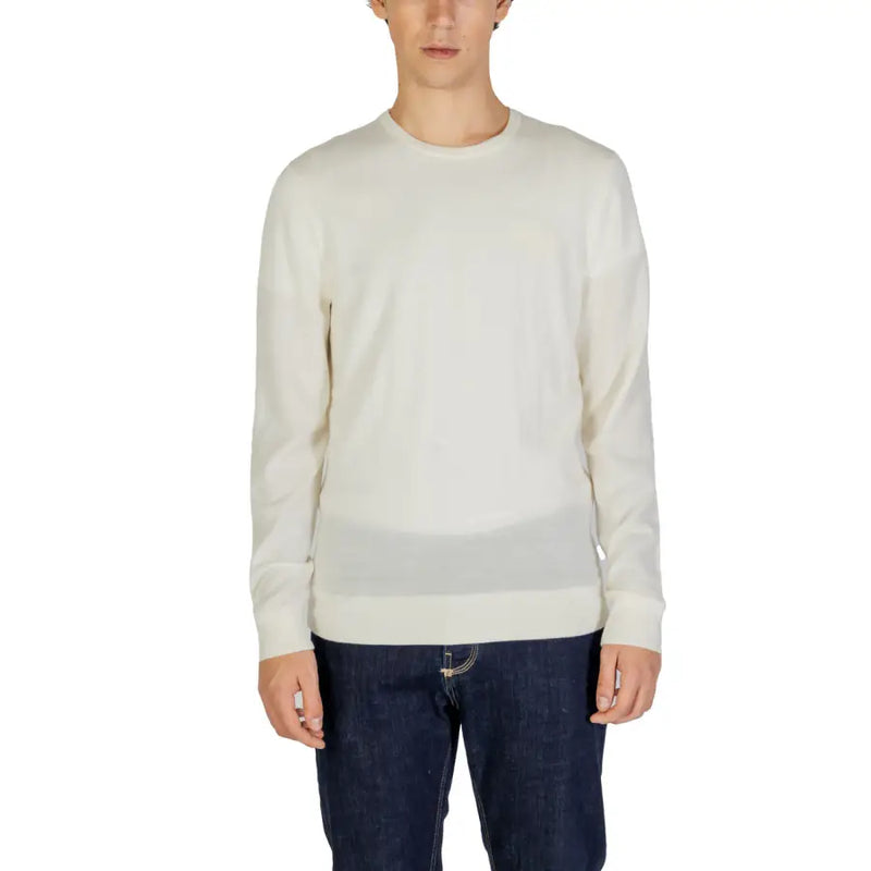 Cream-colored crewneck sweater with long sleeves and a relaxed fit.